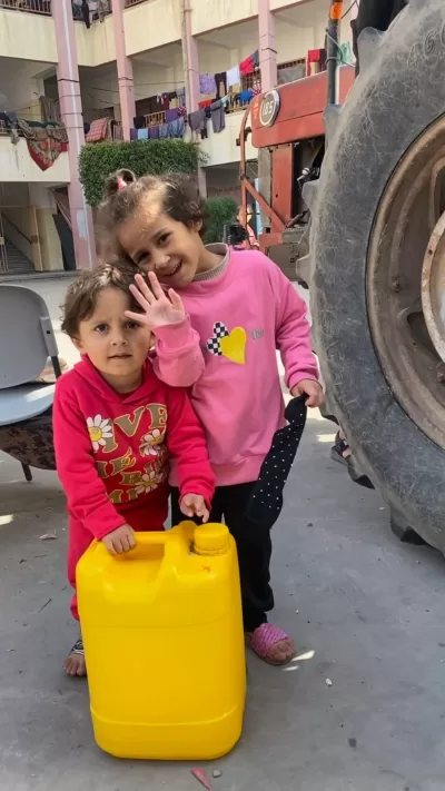 Water tanker filling containers in Gaza